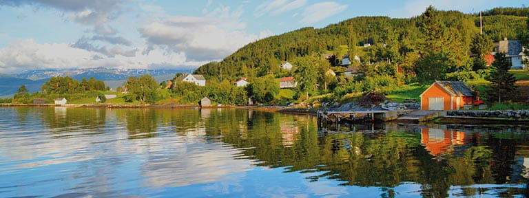 Houses along the fjord in Hardangerfjord, Norway